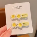 Close-up of cute yellow and white frangipani flower hair clips on a professional display card. - Small Frangipani Yellow Large Duckbill Clip