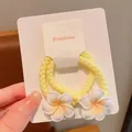 Sweet pair of yellow braided elastic hair ties featuring white plumeria flower accents - Large Frangipani Thick Hair Tie