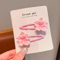 Close-up of pink cherry blossom hair clips on a white display card - Large Peach Blossom BB Clip