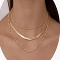Gold plated three-layer layered necklace featuring snake and figaro chains on model - Millet Bead Snake Bone Cuban Chain / Gold