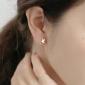 Minimalist S999 sterling silver star stud earrings shown on ear for a delicate look - Star Style (C00325-1) / 990 Silver / Silver