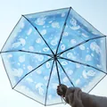 Transparent folding umbrella featuring an ethereal blue jellyfish pattern against the sky - Automatic / Jellyfish Pattern