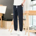 Casual men's navy blue cotton linen jogger trousers featuring a white drawstring waist. - M / Navy Blue
