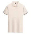 Detail view showing the front of a minimalist cream-colored men's short-sleeved polo shirt - Khaki