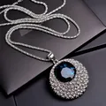 Close-up of sparkling blue crystal pendant on a silver titanium steel long chain - Shell Necklace (019)