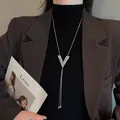 Elegant V-shaped crystal pendant long necklace on model detail view - V-Shaped Tassel Necklace (026)