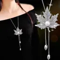 Detailed macro view of a silver maple leaf sweater necklace with pearl and sparkling crystals - Silver Maple Leaf Style (333)