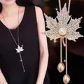 Long sweater chain necklace featuring a rhinestone maple leaf pendant with a center pearl - Gold Maple Leaf Style (334)