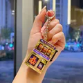 Retro electroplated mini slot machine keychain held by hand for bag pendant - Suncity Style / Gold
