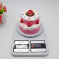 Pink and white slow-rebound squishy double-layer strawberry cake toy on scale - Slow Rebound Strawberry Cake