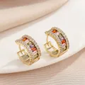 Close-up of gold hoop earrings with multi-colored rectangular gemstones and zircons - Multicolor Zirconia (KC Gold)