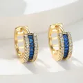 Elegant gold hoop earrings featuring central blue baguette zircons and clear side stones - Blue Zirconia (KC Gold)