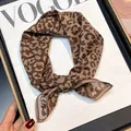 Leopard print silk cotton blend square scarf accessory displayed on a magazine - Khaki Leopard