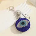 Porte-clés œil de démon en strass étincelants avec des accents de cristal bleu foncé - Oeil Ouvert Rond