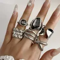 Close-up of a vintage silver-tone ring set featuring geometric dark faceted gemstones. - 6-Piece Minimalist Geometric Style (32490-ring-S)