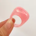 Close-up of minimalist pink acrylic oval ring with transparent resin finish - Pink (31761)