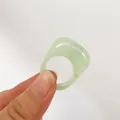 Detailed close-up of a light green translucent acrylic oval ring with smooth finish - Light Green (31761)