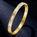 Elegant gold-plated titanium steel bangle featuring white shell inlay and three zircons - Shell Bangle / Gold