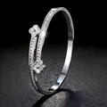 Elegante roestvrijstalen klaverarmband met pavé-kristallen en wit schelpen inlegwerk - Zilver