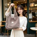 Korean style large capacity brown polka dot tote bag carried by woman in a cafe setting - Coffee Brown with Off-White Hearts
