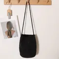 Chic black shimmering woven straw bucket bag for elegant beach vacations - Black
