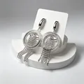 Elegant silver-tone tassel earrings featuring shimmering rhinestones on a white display card - Silver