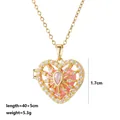 Detail view of gold heart locket necklace with pink stone and crystal accents - Pink