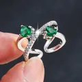 Elegant silver crossover open ring with two green zircons and sparkling pavé stones - Adjustable Open / Silver