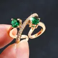 Elegant gold-plated cross-wrap open ring with green zircons and sparkling accents. - Adjustable Open / Gold