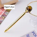 Elegant golden metal ballpoint pen topped with a polished natural tiger eye gemstone - Tiger Eye Sphere Style (6186451919089)