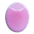 Soft pink silicone infant shampoo and facial cleansing brush with dual textures. - Pink