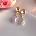 Detailed macro view of baroque pearl earrings with silver needle posts - Natural Pearl / Irregular Gold-Tone Base Baroque Artificial Pearl Style (EH66-1)