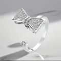 Close-up of silver-plated adjustable ring featuring sparkling zircon bow motif. - Adjustable Open / Bowknot Rotating Style