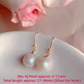 Detailed view of elegant white pearl drop earrings on a white ceramic plate - Natural Pearl / Gold-Tone Ear Hook Double Artificial Pearl Style (EH66--No. 6)