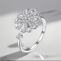 Detailed macro view of an adjustable silver ring with rotating zircon flower motif - Adjustable Open / Petal Rotating Style