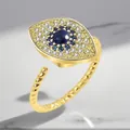 Detail of gold evil eye rotating ring with blue and white cubic zirconia stones. - Adjustable Open / Evil Eye Rotating Style (Gold)