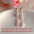 Macro view of asymmetric natural freshwater pearl earrings showing elegant luster detail - Natural Pearl / Asymmetrical Artificial Pearl Strand Style