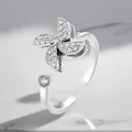 Detailed close-up of a silver-plated rotating windmill ring with sparkling zirconia. - Adjustable Open / Windmill Rotating Style