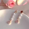 Detail view of elegant freshwater pearl drop earrings with sparkling zircon accents - Natural Pearl / Square Zirconia Wrapped Artificial Pearl Style (EH66--14)