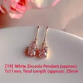 Macro detail of rectangular white zircon drop earrings displayed on white ceramic plate - Natural Pearl / Rectangular White Zirconia Style (EH66--No.19)