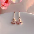 Macro detail of gold-plated crown earrings with marquise-cut white zirconia stones - Natural Pearl / Crown Floral White Zirconia Style (EH66-20)