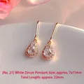 Detailed view of elegant teardrop white zirconia earrings with gold hooks, 22mm total length. - Natural Pearl / Pear-Shaped White Zirconia Drop Earrings (EH66-21)