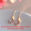 Close-up of elegant gold-tone drop earrings featuring square white zircon stones - Natural Pearl / Square White Zirconia Gold Style (EH66--No. 22)