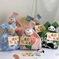 Colorful knitted gift bags with plush charms and greeting cards for celebrations. - 16x28cm / Blue Base White Flower (With Hat Bear)