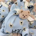 Light blue knitted gift bag featuring a cute bear pattern and decorative ribbon detail. - 16x28cm / Light Blue Base Jacquard Bear (With Ribbon Bear)