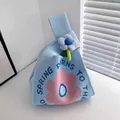 Handmade light blue knitted wrist bag with pink flower pattern and 3D floral charm - 16x28cm / Blue Base White-Pink Sunflower (With Blue Flower)