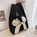 Elegant black knitted wrist bag featuring a large white bow pattern for weddings and gifts - 16x28cm / Black-White Bow Style