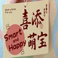 Close-up view of a decorative tag on a pastel-colored knitted mini gift bag. - 10 Sheets Set / New Baby Card