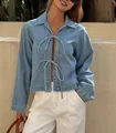 Detail of a stylish French-style tie-up denim jacket with bow front closures for women - S / Light Blue