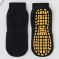 Black anti-slip trampoline socks with yellow rubber grip pads for yoga and floor use - Black